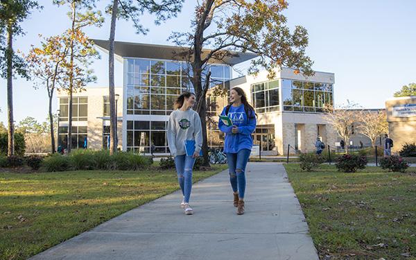 two students walking on the uwf main campus